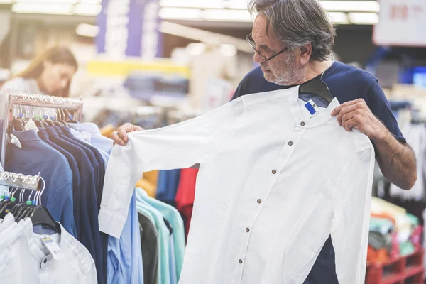 Elbiselere görünen adam