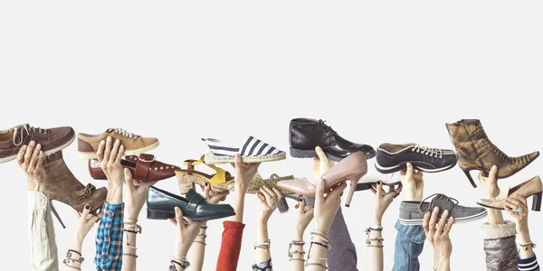 Руки Держащие Разные Туфли Изолированном Фоне — стоковое фото