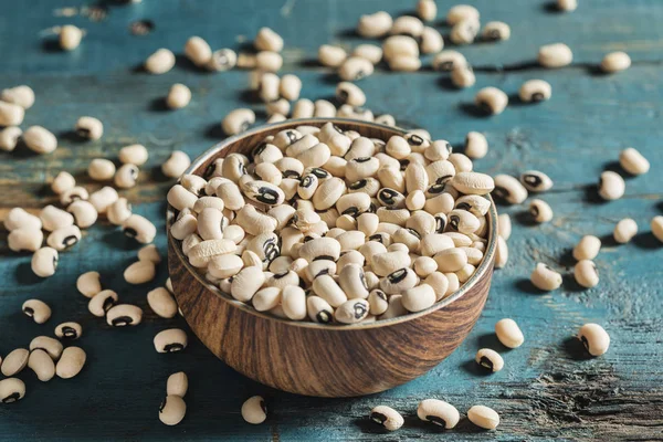 White beans on wooden background