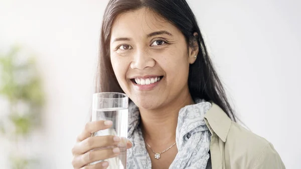 Young asian woman drinking water