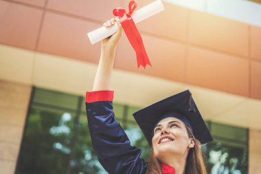 Young female students graduating from university clipart