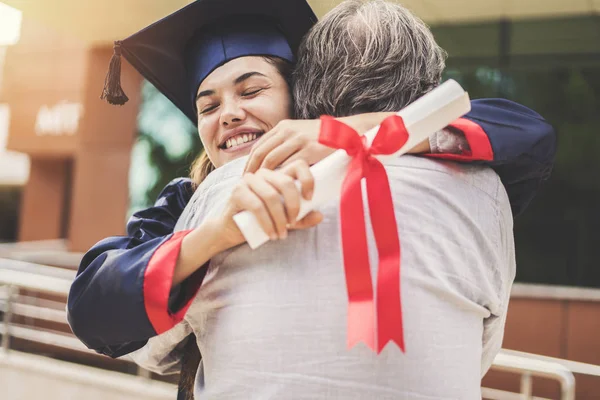 Graduated student hugging her father