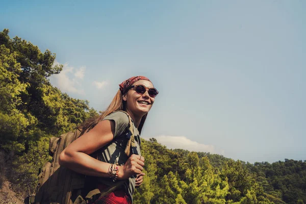 Trekking with backpack in the forest