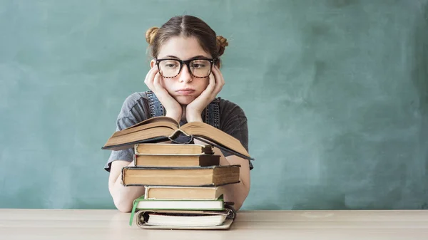 Bored young student girl with books