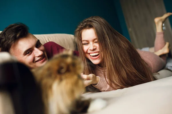 photos of a young couple at home with a cat