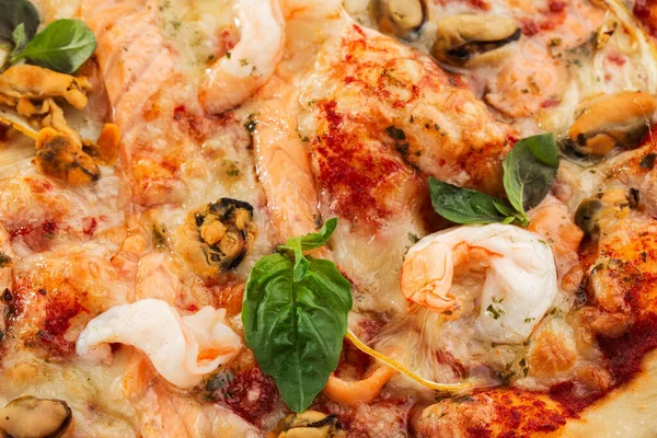Итальянская пицца из морепродуктов с креветками, кальмарами, мидиями, свежими травами и моцареллой на корневом основании, смотрящемся сверху на сером фоне. Горизонтальное фото . — стоковое фото