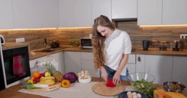Sağlıklı yiyecekler, sebze salatası. Diyet olsun. Diyet Konsepti. Mutfakta sebze salatası hazırlayan bir kadın resmi. Sağlıklı yaşam tarzı konsepti, salata için biber kesen güzel bir kadın. 4k