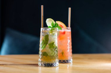 İki bardak çilekli ve limon ve naneli klasik mojito kokteyli, soğuk, ferahlatıcı içecek ya da parlak arka planda buzlu içecek. Genel görünüm, kopyalama alanı. Kafe menüsü reklamı