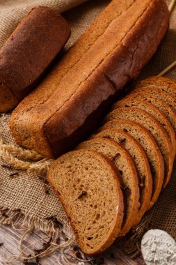 Ev yapımı pişirme. Gri ekmek, un ve süt ile ahşap doğrama tahtasının üzerinde çavdar ekmeği..