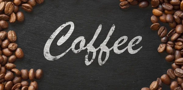 Кофе написан от руки на темном фоне в обрамлении из кофейных зерен — стоковое фото