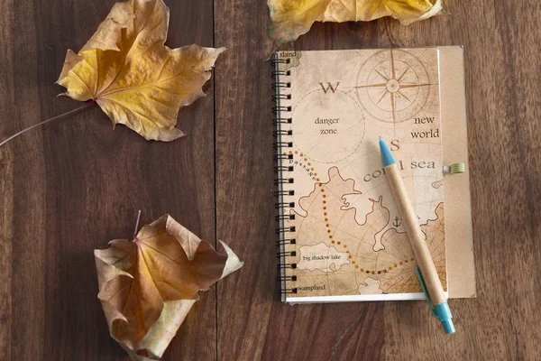 Travel journal on wood table — Stock Photo, Image