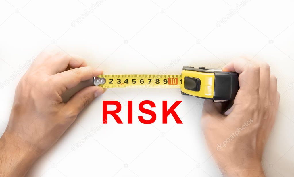 hands holding measure tape measuring risk