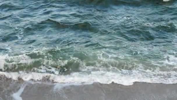 Θαλασσινό νερό ωκεανού πλένει την αμμώδη, βραχώδη ακτή — Αρχείο Βίντεο