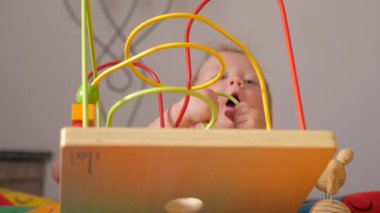 Gifts for toddlers, babies. Colorful toy appealing to hold. Montessori background. Toddler developing fine motor skills. Supporting the development of fine motor skills. Fine motor skills developing.