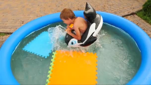 Children and nature. Summer time. Traveling concept. Vacation. Travel with children. Water games. Happy childhood concept. Cheerful children playing in water. Water pool on front, back yard. — Stock Video