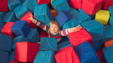 Indoor leisure activities, sports, recreation. Fun for preschoolers. Boy with arms raised up in mid-air. Welcome gesture. clipart