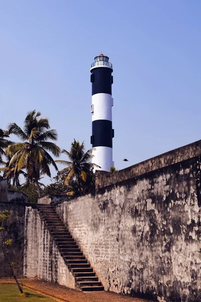 Anchuthengu Lighthouse behind the wall of the old Ford. Wall wit