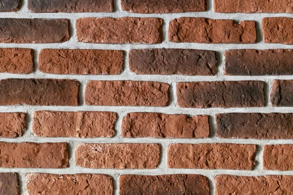 red and black decorative bricks with cement. wall close. horizontal view