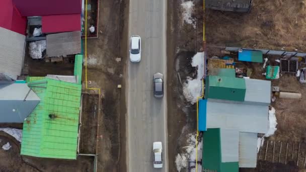 Aerial view the car goes on the road in the village. — Stock Video