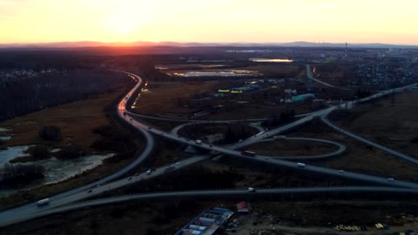 Huge road junction full of cars and trucks in countryside in winter, aerial view. — Stock Video