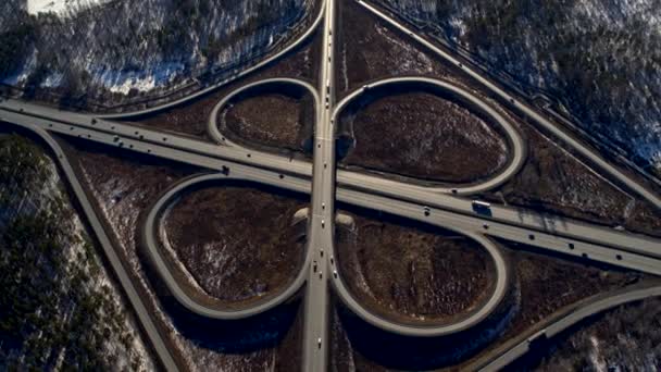 Huge road junction full of cars and trucks in countryside in winter, aerial view. — Stock Video