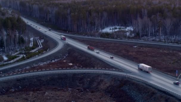 Aerial view of the truck that rides on a huge interchange at sunset. — Stock Video
