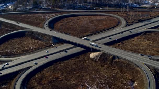 Enorme cruce de carreteras lleno de coches y camiones en el campo en invierno, vista aérea . — Vídeos de Stock