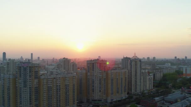 Flygfoto över den ljusa orange solnedgången över staden. — Stockvideo