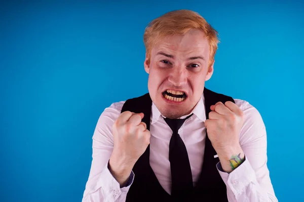 emotional portrait of a crazy guy in close-up. concept: the nervous breakdown, mental disease, headaches and migraine.