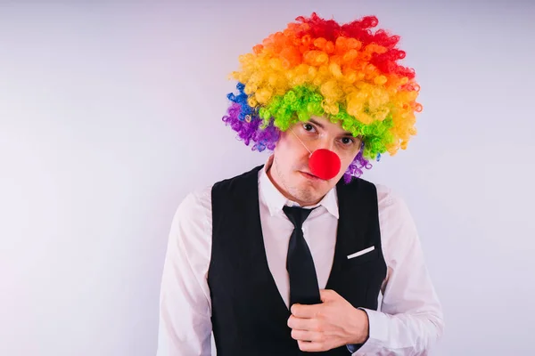 Office worker in clown wig, clown concept at work. Businessman with clown wig isolated on white