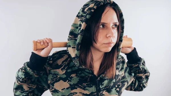 Young cute girl with baseball bat, Girl with a bat. girl or criminal woman, holding baseball bat in hand.  Sport and training