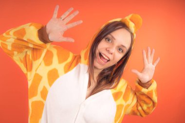 pijama bir zürafa şeklinde. duygusal portre turuncu bir arka plan bir kız. takım elbiseli çılgın ve komik bir kadın. çocuk partileri için animatör