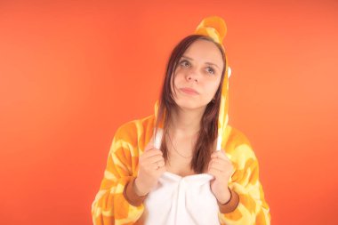 pijama bir zürafa şeklinde. duygusal portre turuncu bir arka plan bir kız. takım elbiseli çılgın ve komik bir kadın. çocuk partileri için animatör