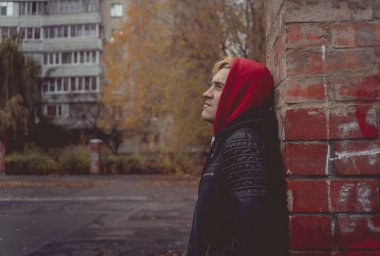 Genç bir adam sokakta yürürken bir deri ceketli. duygusal portre. bir adamın temiz hava girer. sokak tarzı kıyafetler bir şehirde yürümek için. Giyim Katalog için duvar kağıtları.