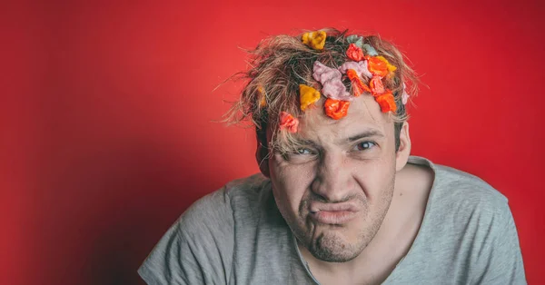 Gum in his head. Portrait of man with chewing gum in his head. Man with hair covered in food. Closeup portrait of an angry  man who has opened a tin of food  and it has ended up in his hair , red back