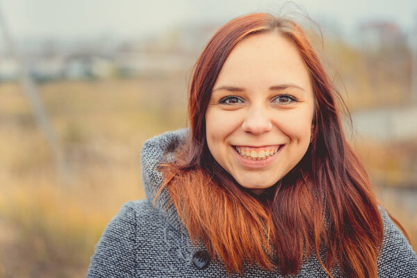 Girl on a background of yellow leaves of autumn trees. Autumn photo session. Autumn woman walking outdoors