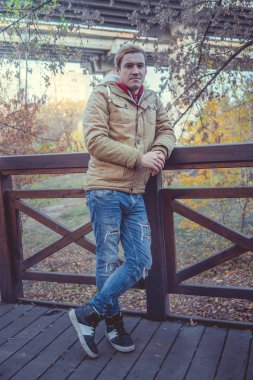 Sonbahar Park modern yakışıklı adam. Mevsimlik moda. Sonbahar stil. Arka plan Sonbahar Park genç bir adam portresi kapatın