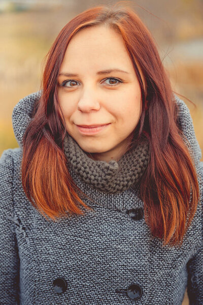 Girl on a background of yellow leaves of autumn trees. Autumn photo session. Autumn woman walking outdoors