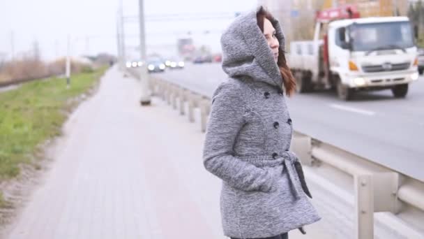 Young Girl Gray Coat Autumn Walks Fence Roadway — Stock Video