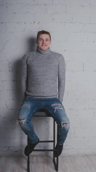 Guy Warm Sweater Chair Gray Background Man Posing Brick Wall — Stock Photo, Image