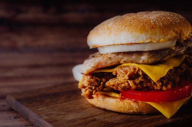 Ev yapımı hamburger veya kahverengi kağıt üzerinde sandviç. Lezzetli sandviç hamburger eti veya domuz jambon peynir ve taze sebze ile. Hamburger veya sandviç popüler fast food brunch veya öğle yemeği için olur. Peynir