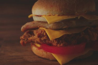 Ev yapımı hamburger veya kahverengi kağıt üzerinde sandviç. Lezzetli sandviç hamburger eti veya domuz jambon peynir ve taze sebze ile. Hamburger veya sandviç popüler fast food brunch veya öğle yemeği için olur. Peynir