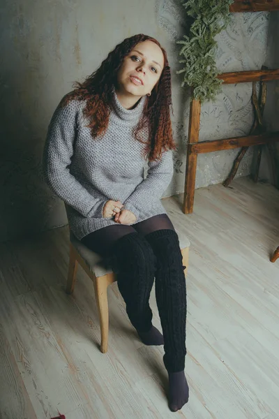 Una Ragazza Con Maglione Che Posa Contro Muro Grigio Donna — Foto Stock