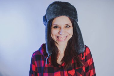 Güzel kız bir fotoğraf stüdyosu poz. Sokak tarzı giyim şapka ve gömlek. 