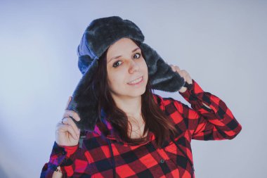 Güzel kız bir fotoğraf stüdyosu poz. Sokak tarzı giyim şapka ve gömlek. 