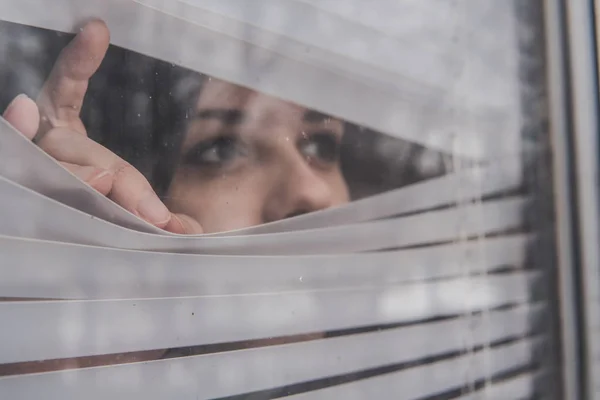 Young Girl Looking Out Blinds — Stock Photo, Image