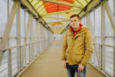 Şehir yolunda günlük giysiler içinde genç yakışıklı bir adam.