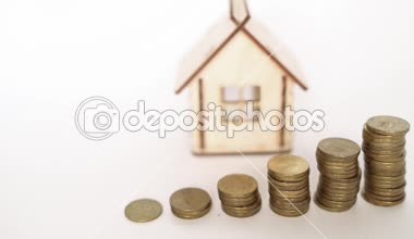 Finansal gayrimenkul, altın paralar ve ev. Konsept: Emlak yatırımı ve konut kredisi finansmanı 