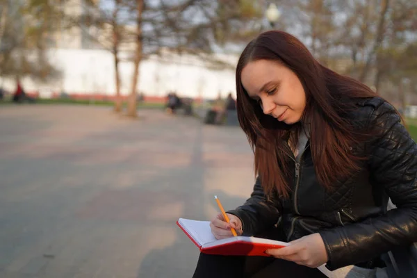 Caddeye Kırmızı Defterle Notlar Yazan Bir Kadın — Stok fotoğraf