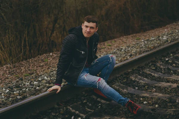 Trendy Young Man Sitting Rails Pensive Male Jeans Leather Jacket — Stock Photo, Image